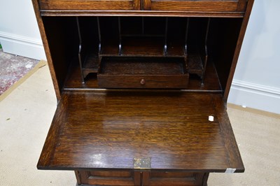 Lot 41 - A 1920s oak bureau cabinet, with a pair of...