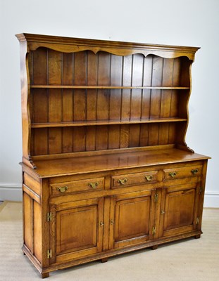 Lot 229 - A reproduction oak dresser with boarded plate...