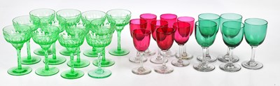 Lot 1592 - A set of twelve 1930s cut green glass wine...