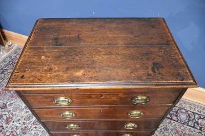 Lot 7 - A late George III oak chest, with four...