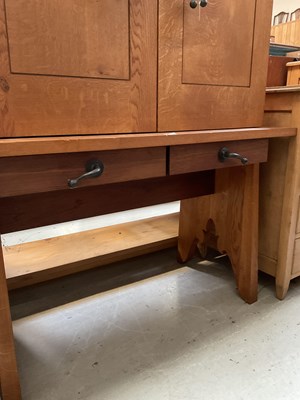 Lot 15 - A modern oak cupboard on stand, with two short...