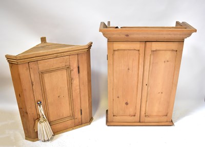 Lot 57 - A pine corner wall-hanging cupboard with...