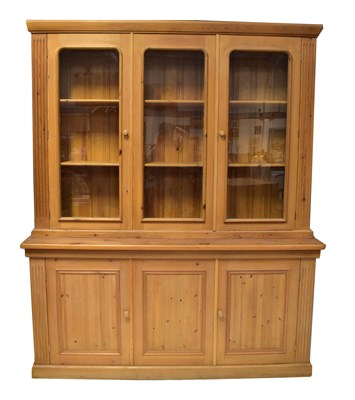 Lot 52 - A large pine dresser/bookcase with glazed...