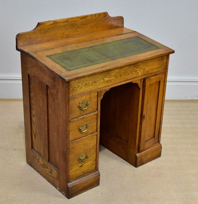 Lot 23 - An early 20th century oak desk with raised...