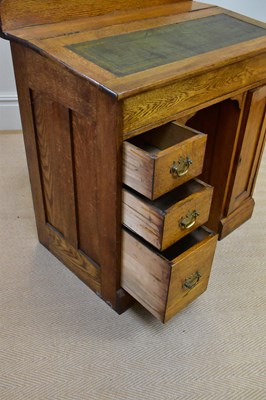 Lot 23 - An early 20th century oak desk with raised...