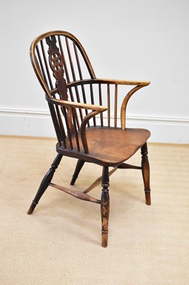 Lot 28 - A 19th century elm seated Windsor elbow chair...