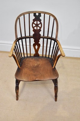 Lot 28 - A 19th century elm seated Windsor elbow chair...