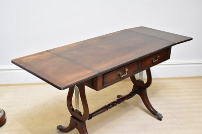 Lot 270 - A reproduction mahogany sofa table, on lyre...