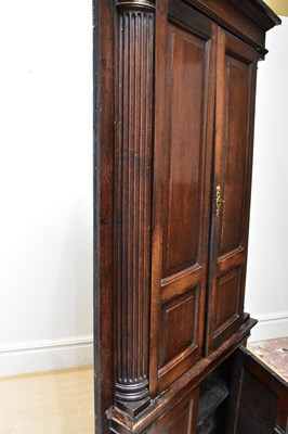 Lot 13 - A George III oak corner cupboard, with two...