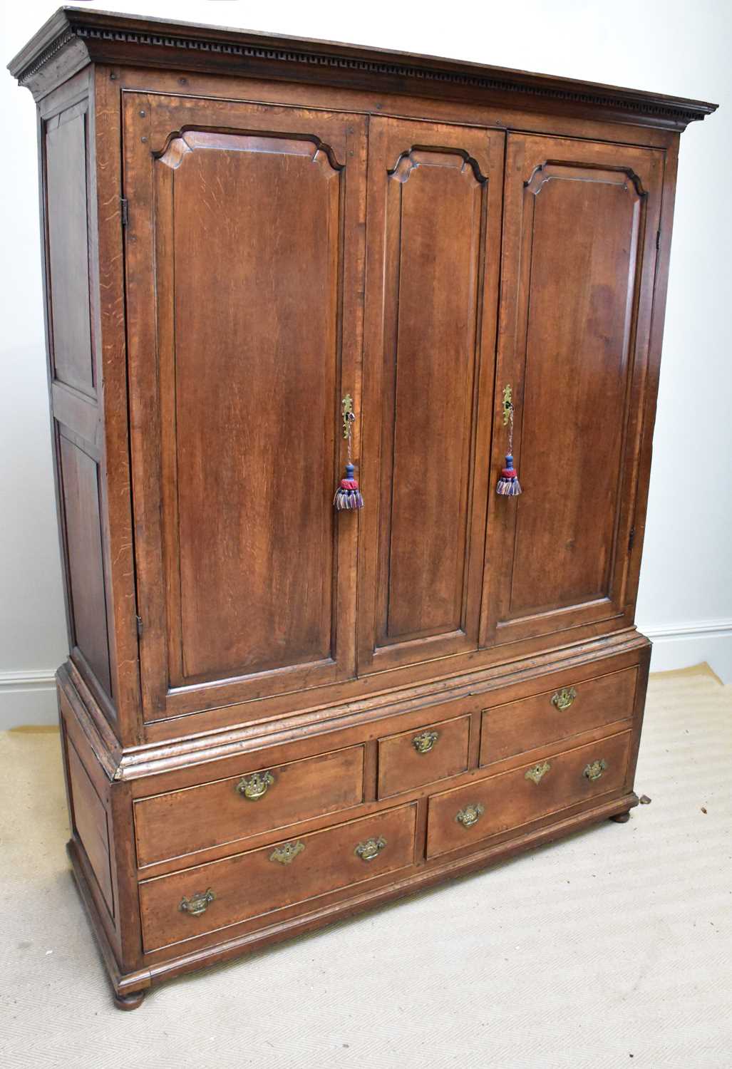 Lot 5 - A George III oak livery cupboard, with two...