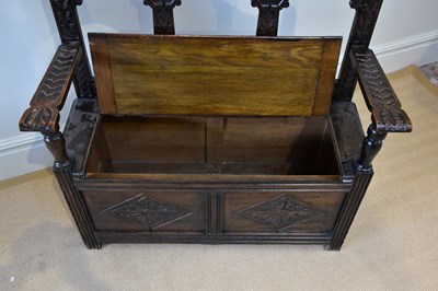 Lot 43 - An early 20th century carved oak hall settle,...