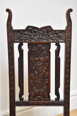 Lot 32 - A carved oak rush seated hall chair, an oak...