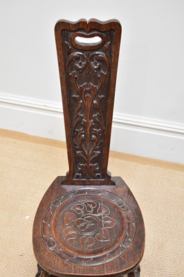 Lot 32 - A carved oak rush seated hall chair, an oak...