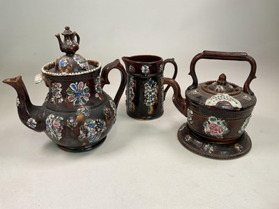 Lot 300 - BARGEWARE; a glazed teapot, kettle on stand...