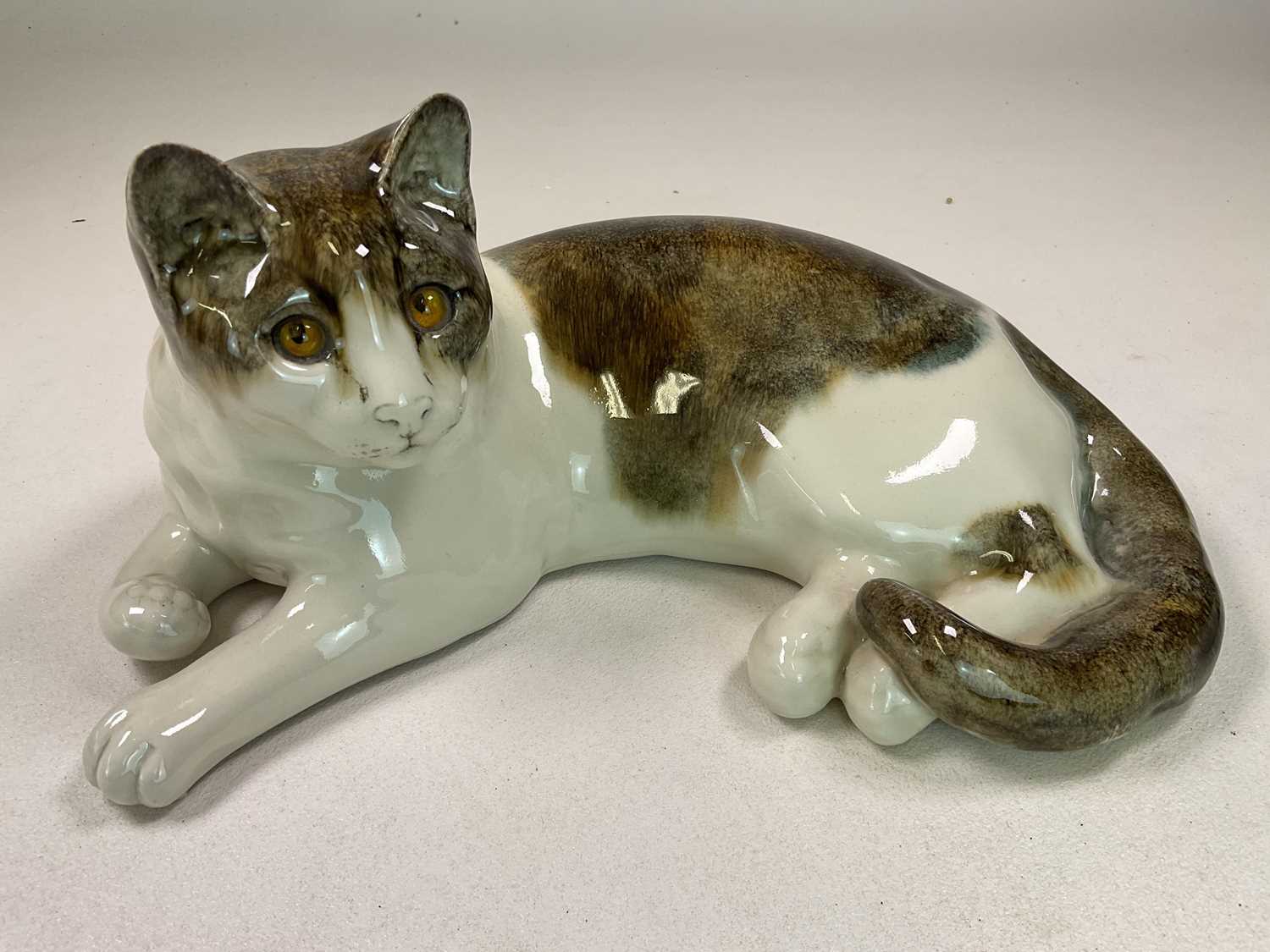 Lot 268 - WINSTANLEY; a cat in recumbent position,