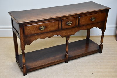 Lot 233 - A reproduction oak dresser base, with three...