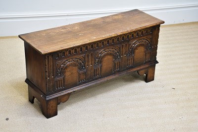 Lot 247 - A reproduction oak blanket chest with carved...