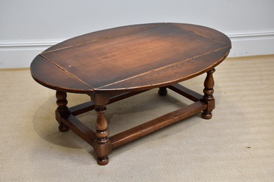 Lot 265 - A reproduction oak drop-leaf coffee table of...