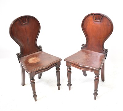 Lot 24 - A pair of Regency mahogany hall chairs with...