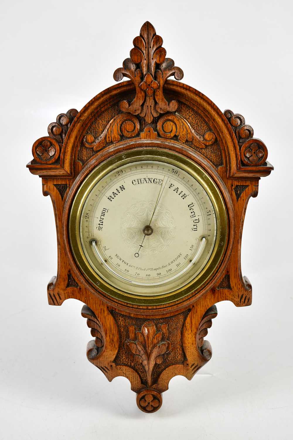 Lot 419 - A late Victorian carved oak barometer, the...