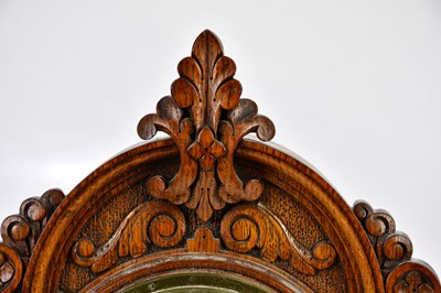 Lot 419 - A late Victorian carved oak barometer, the...