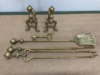 Lot 135 - A brass fire companion set comprising two fire...