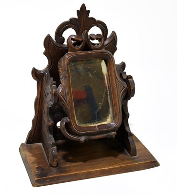 Lot 94 - A Black Forest shaving mirror, with carved...