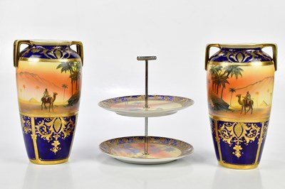 Lot 1413 - NORITAKE: a pair of hand painted twin handled...