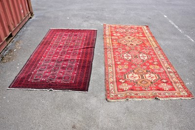 Lot 450 - A red ground rug in the Bokhara style with...