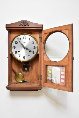 Lot 351 - TAKANO; an eight day wall clock, the silvered...