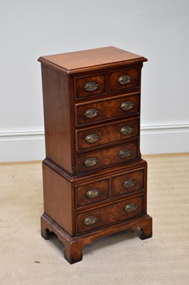 Lot 249 - A reproduction small sized walnut chest of six...