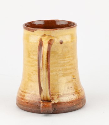 Lot 65 - Leach Pottery; a slipware mug decorated with a...