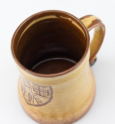 Lot 65 - Leach Pottery; a slipware mug decorated with a...