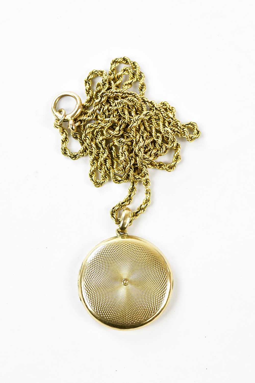 Click H Locket Lot 2456 - A 15ct yellow gold locket with engine
