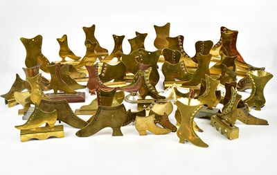 Lot 783 - A large collection of brass mantel shelf boots,...