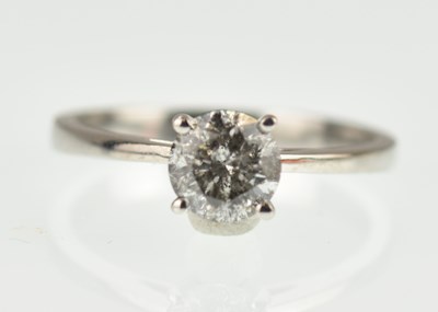 Lot 992 - An 18ct white gold solitaire ring, with round...