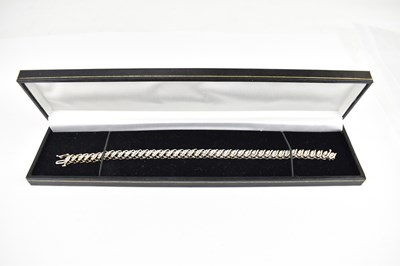 Lot 1038 - A 9ct white gold bracelet, comprising forty...