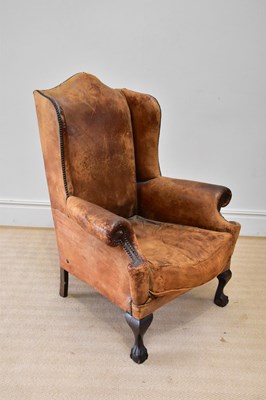 Lot 193 - An early 20th century wingback armchair...