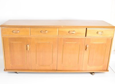 Lot 11 - PRIORY; a four-drawer, four-cupboard...
