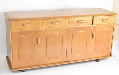 Lot 11 - PRIORY; a four-drawer, four-cupboard...