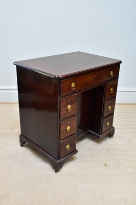 Lot 59 - A George III mahogany kneehole desk, the seven...