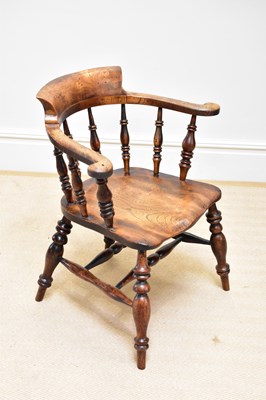 Lot 1213 - An elm seated smoker's bow chair on turned...