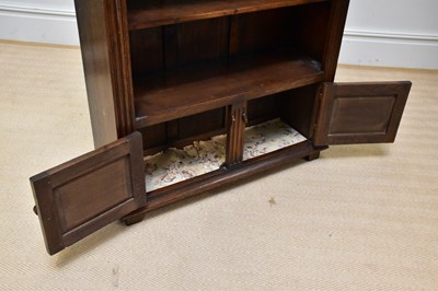 Lot 1080 - A reproduction oak bookcase with two cupboard...