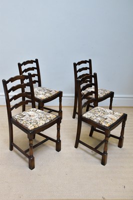 Lot 1130 - A set of four reproduction oak ladder back...