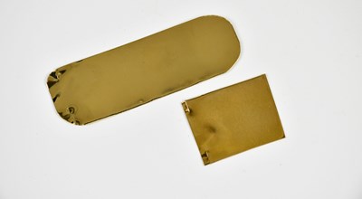 Lot 2519 - Two pieces of yellow metal, one bears label...