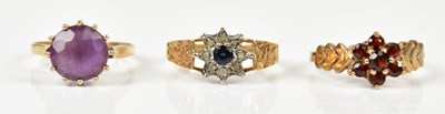 Lot 200 - Three 9ct gold dress rings including a garnet...