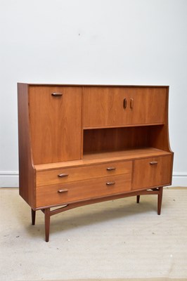 Lot 1015 - A mid century teak sideboard with raised back,...