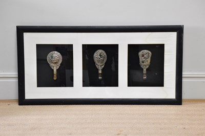 Lot 1308 - Three white metal Tibetan hand mirrors, framed...