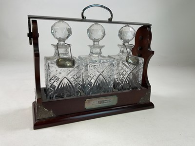 Lot 329 - A three bottled tantalus, with two hallmarked...