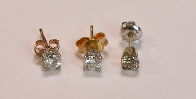 Lot 430 - Two  single diamond set ear studs, each round...